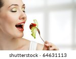 A beautiful slender girl eating healthy food - stock photo